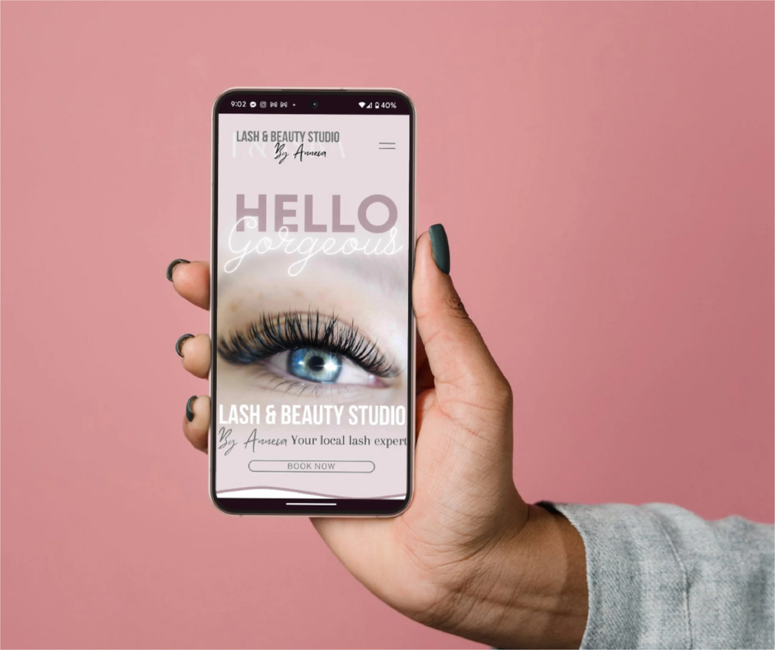 Handing holding mobile phone with responsive website design of Lash & Beauty Studio by Anneca.